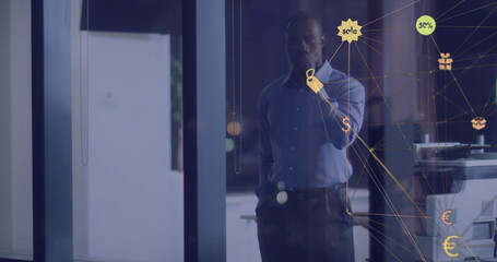 Image of network of connections with icons over african american businessman thinking in office