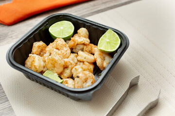 A view of a container of tequila lime shrimp.