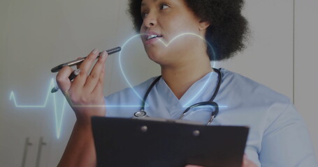 Image of cardiograph and heart over biracial female nurse talking on smartphone