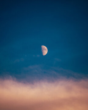Half Moon in a Colorful Twilight Sky with Soft Clouds