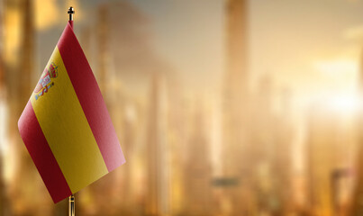 Small flags of the Spain on an abstract blurry background