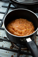 A view of a saucepan of guava puree.