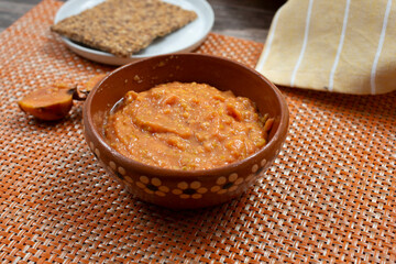 A view of a clay bowl of guava puree.