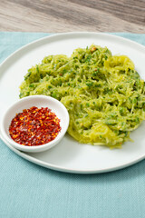 A view of a plate of pesto spaghetti squash.