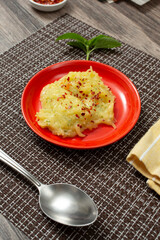 A view of a small plate of spaghetti squash Alfredo, topped with crushed red pepper.