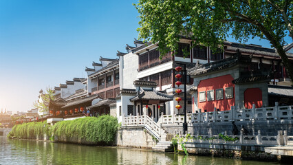 Serene Waterfront View of Traditional Chinese Architecture in Daylight