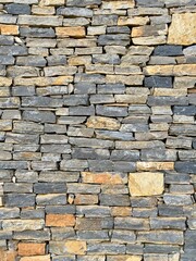 Rustic Stone Wall Texture. Close-up of a stone wall texture, ideal for backgrounds, construction themes, or architectural designs.
