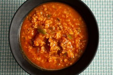 A top down view of a bowl of jambalaya soup.