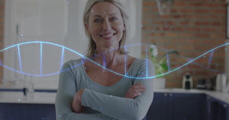 Image of dna strand over portrait of caucasian woman at home