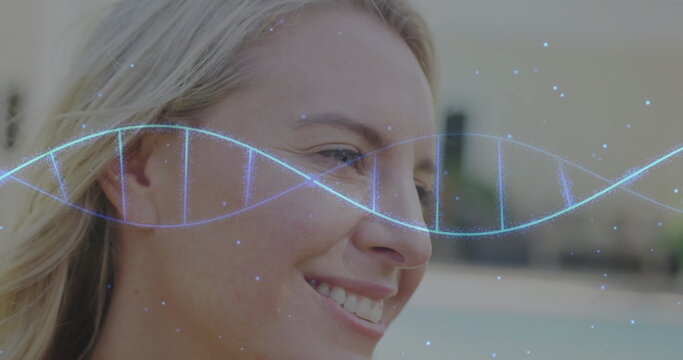 Image of dna strand over caucasian woman smiling
