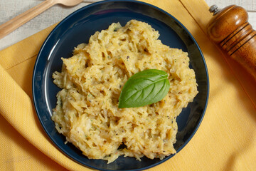 A top down view of a plate of spaghetti squash Alfredo.