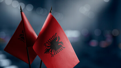 A small Albania flag on an abstract blurry background