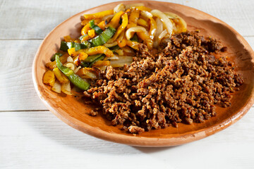 A view of a plate of ground beef fajitas.
