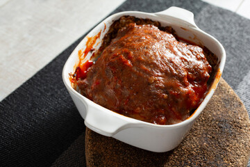 A view of a small baking dish of meatloaf.