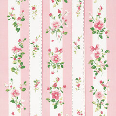 A pattern of small roses and bows in pink and green on a white, printed fabric with long strips of fabric. The background is pink, with a white border around the edge of each strip of material. 