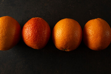 A top down view of a row of blood oranges.