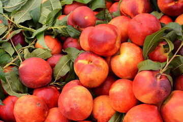 a beautiful fragrant ripe nectarine, the view from the top. Nectarines in the market. A group of colorful nectarine fruits on a market.