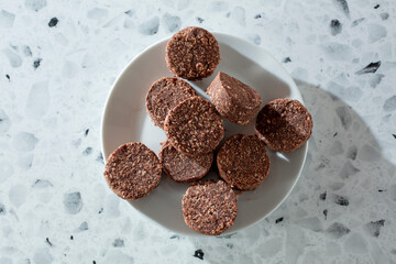 A top down view of a pile of chocolate coconut cookies.