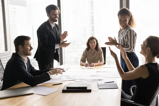 Group of professionals gathered around conference table, clapping hands, encouraging, motivate each other, enjoy collaborative and encouraging work environment. Congratulations, seminar accomplishment