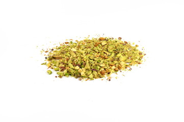 Ground, milled, crushed or granulated pistachio pile isolated on white background. Scattered pistachio nut pieces isolated. Break chopped pistachios pile, fried baked diced pistache on white backgroun