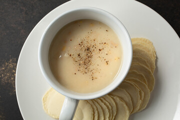 A top down view of a cup of clam chowder.