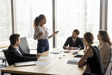 Group of businesspeople engaged in strategic meeting in office, listen speech of African...