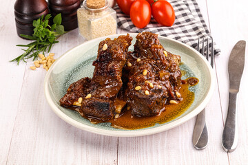 Prepared tasty beef ribs with sauce