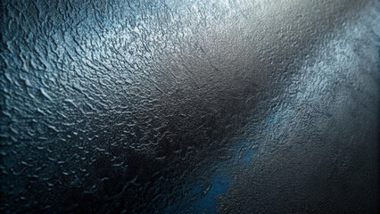 A textured surface with a mix of blue and gray hues creates a rough, almost metallic appearance. Light reflections highlight the unevenness and depths, adding a dynamic effect.AI