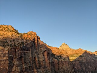Sunrise Over Zion Canyon with Golden Light Flowing Through the Canyon Walls, Various Greenery of Early Spring May Landscape, and River Below