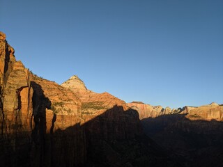 Sunrise Over Zion Canyon with Golden Light Flowing Through the Canyon Walls, Various Greenery of Early Spring May Landscape, and River Below