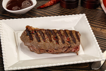 Grilled beef striploin steak with sauce