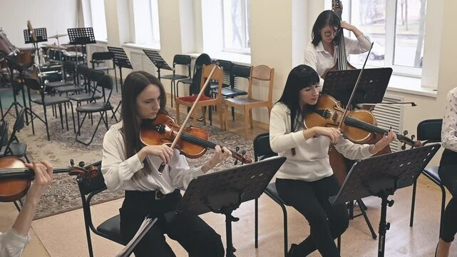 Musicians experiencing tension during rehearsal, with disagreements on musical interpretation. Tension reflects challenges in collaborative creative processes
