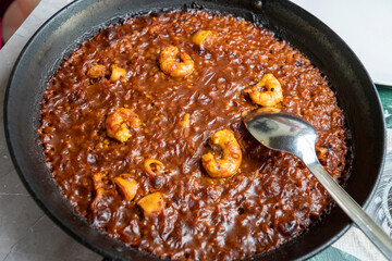 Traditional seafood paella in the pan on a table Murcia Spain