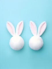 Two pastel colors easter eggs with white bunny ears isolated on blue background, easter background concept