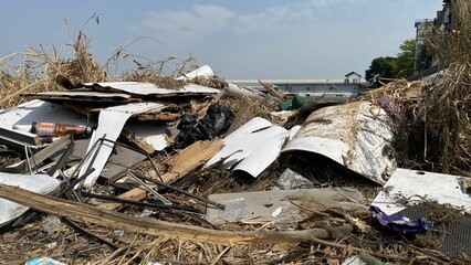 A cluttered scene of debris and waste material, showcasing environmental neglect and the impact of...
