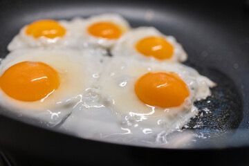 Fried eggs on frying pan