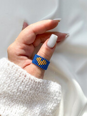 handmade beaded ring for a woman’s hand, Love Colors of Ukraine logo
