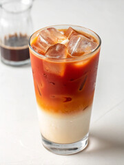 Iced Thai Tea Latte: Layers of rich, sweet Thai tea and creamy milk create a vibrant iced beverage, perfect for a warm afternoon. The dark tea contrasts beautifully with the light milk.