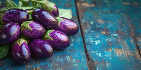 Freshly harvested eggplants on rustic wooden table with vibrant colors