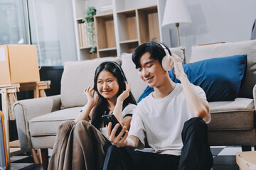 Smiling couple unpacking boxes in new house