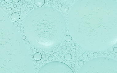 Macro microscope green bubble texture, Close-up Green bubbles and drops oil background . blue green water bubbles, close up golden oil drop for cosmetic...