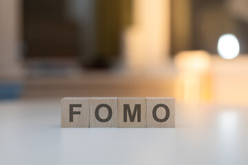 Wooden Cubes on the Table with FOMO Written on Them