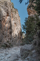 Hiking in the beautiful Samaria National Park in Crete where you hike between a gorge.