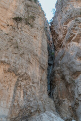 Hiking in the beautiful Samaria National Park in Crete where you hike between a gorge.