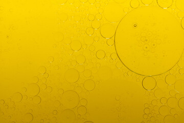 Macro microscope yellow bubble texture, Close-up Yellow bubbles and drops oil background . golden Yellow water bubbles, close up golden oil drop for celebration.