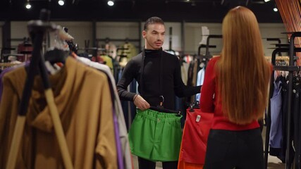 In a contemporary retail environment, a fashion consultant assists a client in selecting stylish and vibrant outfits