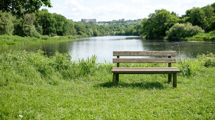 Fototapeta premium Tranquil park bench by a river