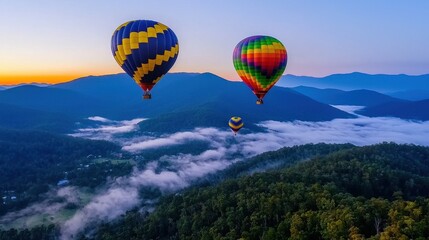 Fototapeta premium Colorful Hot Air Balloons Floating Above Misty Mountains at Sunrise in a Scenic Landscape