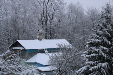 Old home in forest in the snow 