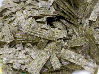 
Seaweed for sushi is cut into pieces. Close up.